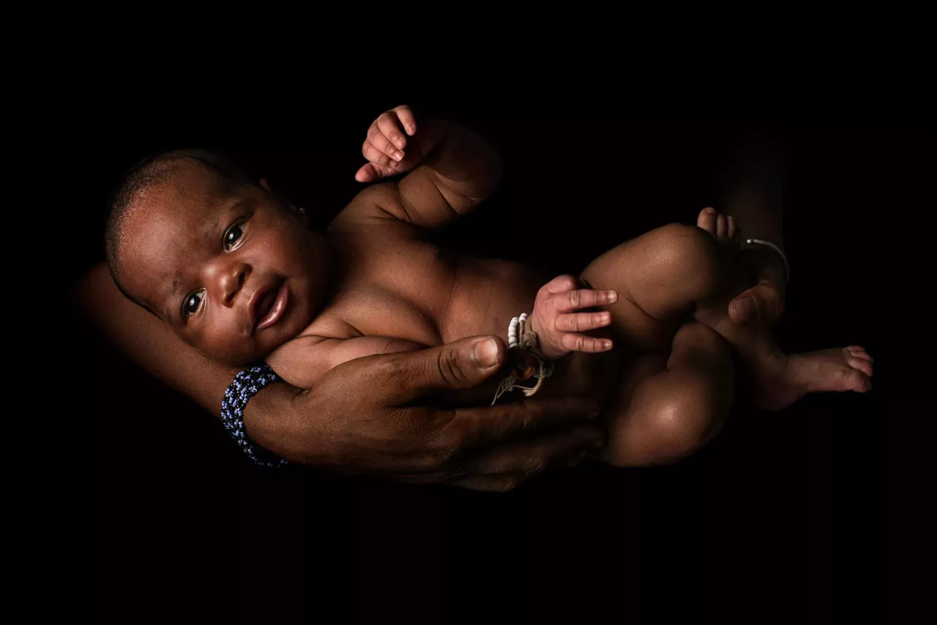 A mother cradles her baby in Mali