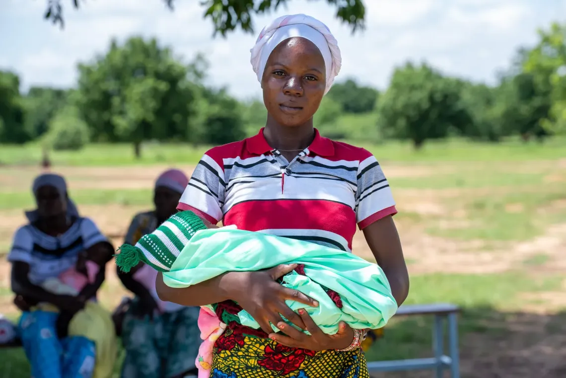 A woman holds her baby in Burkina Faso