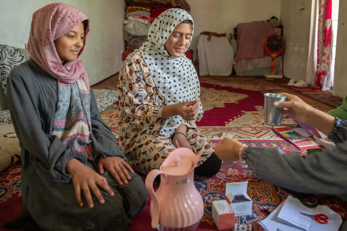 A woman receives MMS in Afghanistan